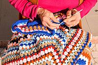 Close-up image of an old woman with knitting needles and wool [IBR125188240]
