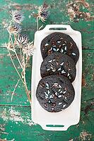 Black cookies with dinosaur sugar [IBR125203172]
