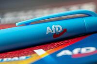 AfD symbolic image: close-up of a flyer and ballpoint pen [IBR113322396]