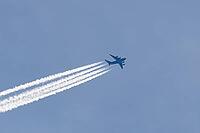 Boeing C-17 Globemaster III military jet aircraft of the United States Air Force USAF flying in a blue sky with contrails or vapour trails behind in the atmosphere, England, United Kingdom [IBR125204146]