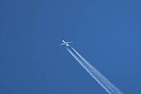 Jet passenger aircraft of TUI airlines flying in a blue sky with contrails or vapour trails behind in the atmosphere, England, United Kingdom [IBR125204147]