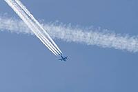 Boeing C-17 Globemaster III military jet aircraft of the United States Air Force USAF flying in a blue sky with contrails or vapour trails behind in the atmosphere, England, United Kingdom [IBR125204148]
