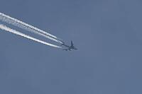 Boeing 747 jumbo jet cargo aircraft of Magma airlines flying in a blue sky with contrails or vapour trails behind in the atmosphere, England, United Kingdom [IBR125204160]
