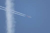 Airbus jet passenger aircraft of Easyjet airlines flying in a blue sky with contrails or vapour trails behind in the atmosphere, England, United Kingdom [IBR125204171]