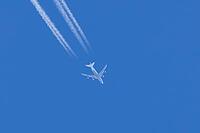 Boeing 747 jumbo jet passenger aircraft of Lufthansa airlines flying in a blue sky with contrails or vapour trails behind in the atmosphere, England, United Kingdom [IBR125204172]