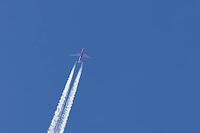 Airbus jet cargo aircraft of DHL airlines flying in a blue sky with contrails or vapour trails in the atmosphere, England, United Kingdom [IBR125204175]
