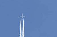 Jet passenger aircraft of Lufthansa airlines flying in a blue sky with contrails or vapour trails behind in the atmosphere, England, United Kingdom [IBR125204176]
