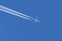 Jet commercial cargo aircraft of Fedex express airlines flying in a blue sky with contrails or vapour trails behind in the atmosphere, England, United Kingdom [IBR125204178]