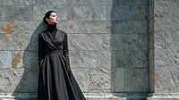 Asian fashion model in a black formald dress resting against a brick stone wall. Confident expression. Hands in pockets, AI generated [IBR125237530]