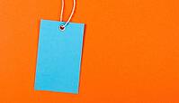 Blue label on a string against a bright orange background. Copy space. Graphic resource, AI generated [IBR125237544]