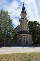 Wooden bell tower of old stone Pertteli church in summer with clouds in the sky, Pertteli, Finland [IBR125242406]