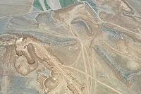 Quarry for the extraction of earthy soil, excavator in the quarry [IBR125242417]