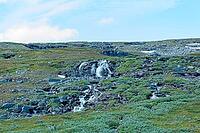 Small mountain stream waterfall cascading over rock formations in summer, Storfjord, Norway [IBR125242438]