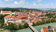 Drone view of red rooftops and river in European town [IBR125261565]