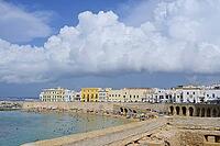 The coast of Gallipoli with lots of people relaxing on the beach and white and yellow buildings [IBR125261574]