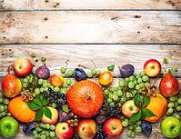 Thanksgiving background with autumn pumpkins, fruits and fall leaves on wooden table. Top view, autumn concept with copy space [IBR125261578]