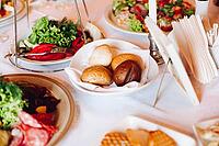 Close-up of delicious meat balls and fish rolls catered on rectangular balls with sticks for snacks. Variety of food on birthday corporate party or wedding celebration [IBR125261610]
