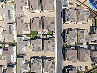 New development real estate. Aerial view of residential houses and driveways neighborhood in south San Diego, Chula Vista. Packed homes. Top view over private houses [IBR125280296]