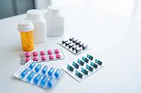 Pills and capsules on white background Medical and pharmaceutical concept representing healthcare treatment prevention and wellness [IBR125280318]