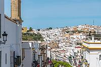 Narrow streets lined with whitewashed historic buildings in the old town of Arcos de la Frontera, Cadiz province, Andalusia, Spain, with colorful details and traditional character [IBR125280353]