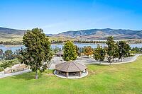 Aerial view of Otay Lakes County Park in Chula Vista, California, a scenic view of a mountain range, the lake. [IBR125280374]