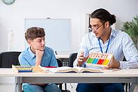 The young father helps his son prepare for the exam [IBR125304601]
