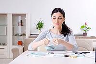 The young woman in a budget planning concept [IBR125304638]