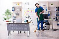 Male handsome professional cleaner working in office [IBR125304649]