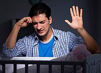 The young father is under stress because the baby cries at night [IBR125304652]
