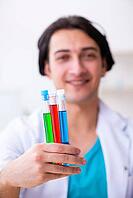 Young male chemist working in laboratory [IBR125304677]