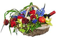 Flower arrangement of roses, orchids, fruits and bottle of wine in basket isolated on white background. Closeup [IBR125304683]