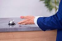 Young businessman at hotel reception [IBR125324058]