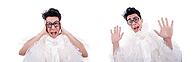 Funny man in a woman's dress against a white background [IBR125324110]