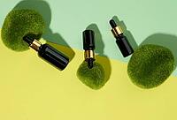 Glass cosmetic brown bottles with a pipette on a green-yellow background with pieces of moss. Cosmetics SPA branding mockup, top view [IBR125331127]