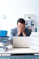 The businessman with lots of paperwork [IBR125331148]