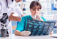 Two doctors are discussing an X-ray MRI image in hospital [IBR125331151]