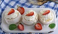 Baked meringue with cream and fresh strawberries, top view [IBR125331154]