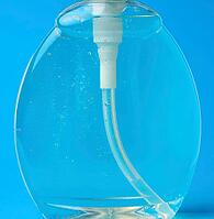 Transparent plastic bottle with a sanitizer for disinfecting hands on a blue background [IBR125331157]