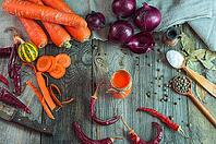 Fresh vegetables and a glass of carrot juice on an old wooden surface, top view [IBR125331198]