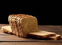 Sliced wheat flour bread on a wooden board. Sandwich bread [IBR125331200]
