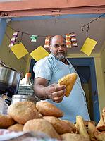 Seller offering Traditional Namkeen snack and Samosas on street food and markets at Jaipur, India [IBR125331202]
