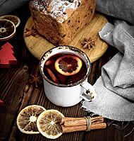 Mulled wine in a white iron mug and baked pie with dried fruits, top view [IBR125331209]