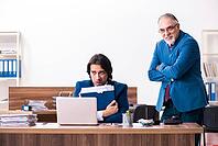 Young and old employees work together in the office [IBR125344245]