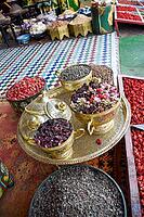 Golden bowls at street stalls in Marrakech with different spices, teas and incense. Morocco [IBR125344250]