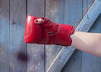 Right hand female in a red boxing glove, blurred background [IBR125344275]