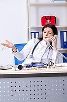 Middle aged doctor in telemedicine concept [IBR125344277]