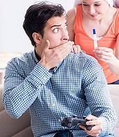 The woman and man are looking at a pregnancy test [IBR125344279]