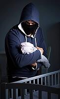 The concept of the criminal stealing baby in human child trafficking [IBR125344297]