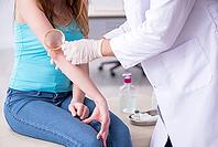 Young arm-injured woman visits young doctor traumatologist [IBR125344325]