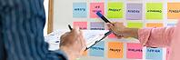 Business people meeting at office and use sticky notes on glass wall in office, diverse employees people group planning work together brainstorm strategy [IBR125344328]